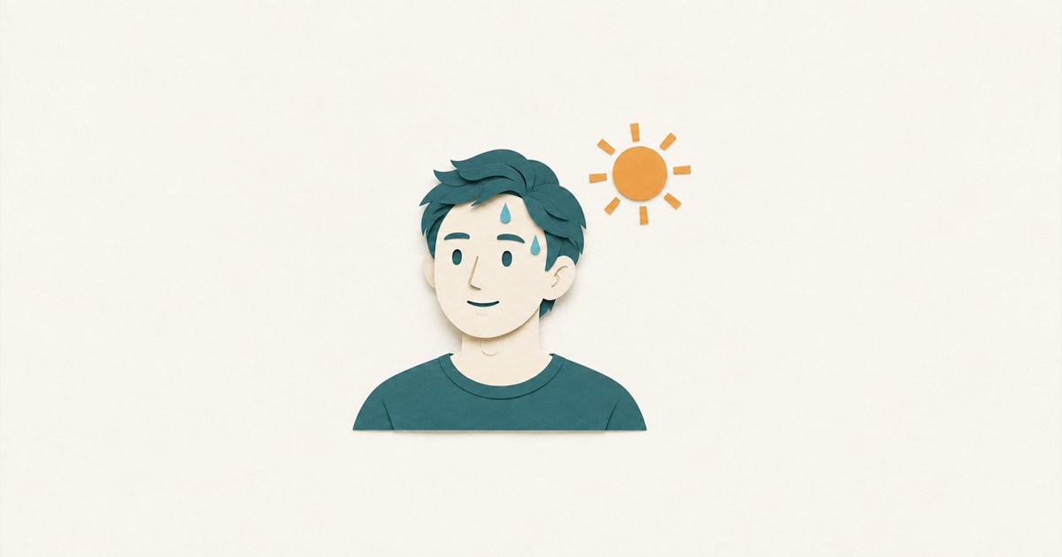 額とこめかみに汗のしずくがある人物と、右上の橙色の太陽を表した紙模型